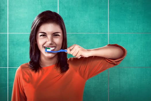 Asian woman brushing her teeth on the bathroom