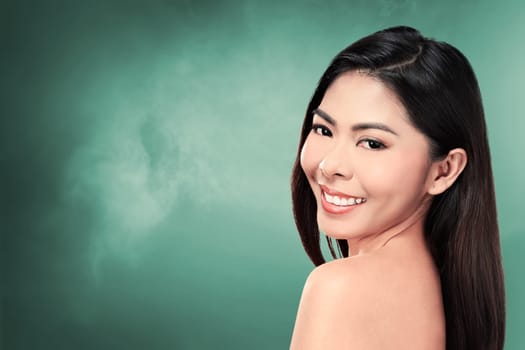 Beautiful face of young adult woman with clean fresh skin over blur background
