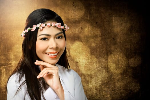 Pretty asian woman wearing flower headband over blur background