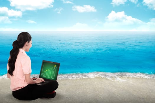 Business woman working on the beach with blue sky background
