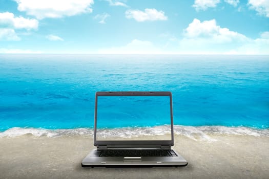Computer laptop on the beach. You can put your design on the screen