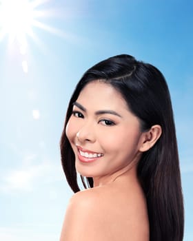 Beautiful face of young adult woman with clean fresh skin over blur background