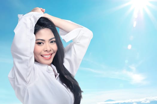 Beautiful face of young adult woman with clean fresh skin over blur background