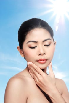 Beautiful face of young adult woman with clean fresh skin over blur background