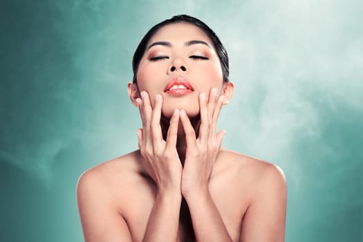 Beautiful asian woman in studio with abstract blur background