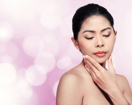 Beautiful face of young adult woman with clean fresh skin over blur background