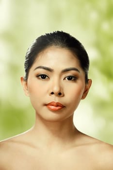 Beautiful face of young adult woman with clean fresh skin over blur background