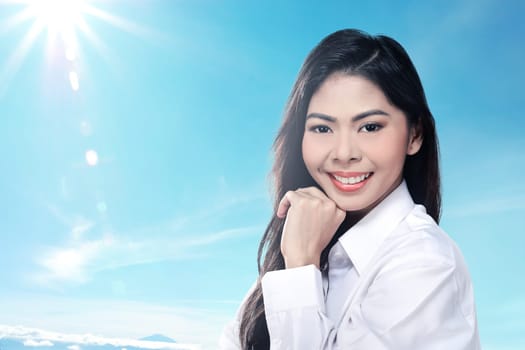 Pretty asian woman smiling wearing white shirt over blur background