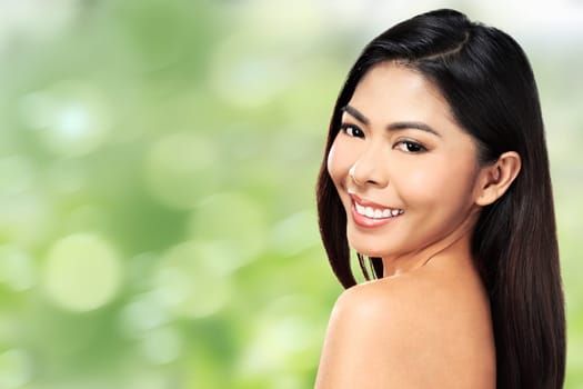 Beautiful face of young adult woman with clean fresh skin over blur background