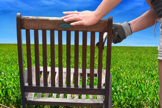 Painting and application of protective eco-friendly paint on a wooden garden chair.    .