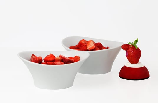 Strawberries in bowls with a strawberry male.