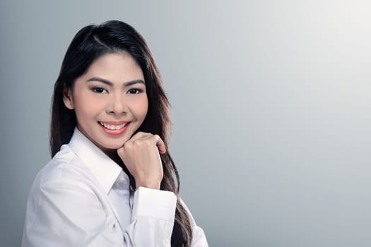 Pretty asian woman smiling wearing white shirt over blur background