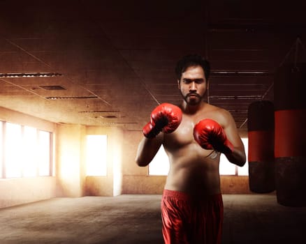 Asian boxer man with punching bags for practicing boxing