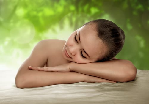 Asian woman have relax time. He have natural skin and look relax with green background