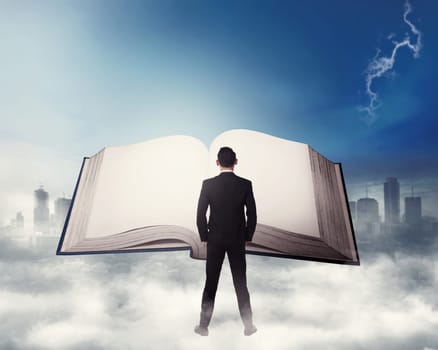 Young business man reading big book. Business education concept