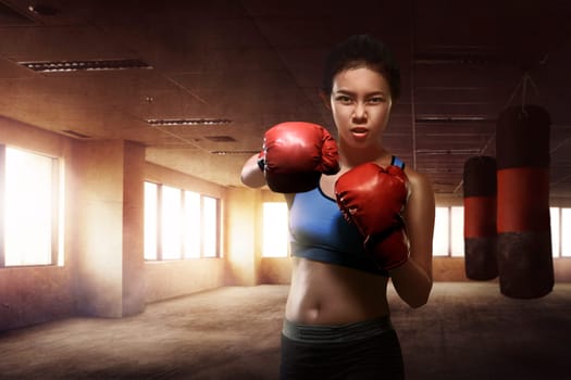Asian woman boxer training boxing on the gym