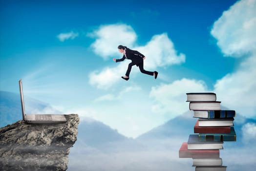 Concept of technology migration with business person jumping from book to laptop