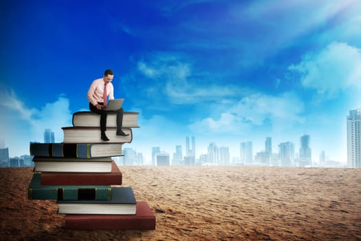 Business person working with laptop on the top of books. Career and education concept