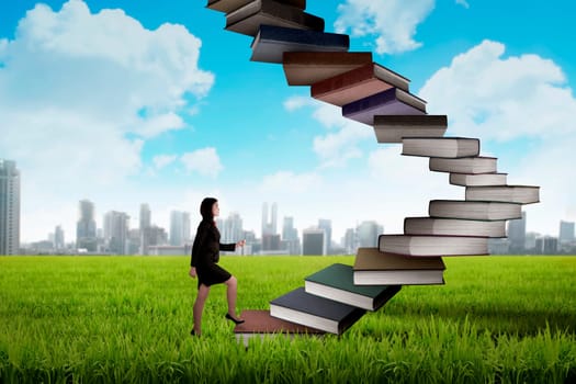 Business person step up flying book that look like stair. Career and education concept