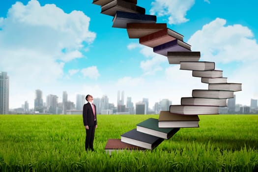 Business person step up flying book that look like stair. Career and education concept