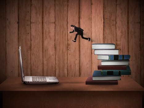 Concept of technology migration with business person jumping from book to laptop
