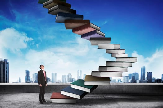 Business person step up flying book that look like stair. Career and education concept