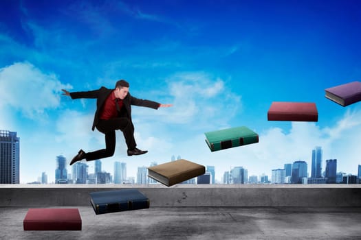 Business person step up flying book that look like stair. Career and education concept