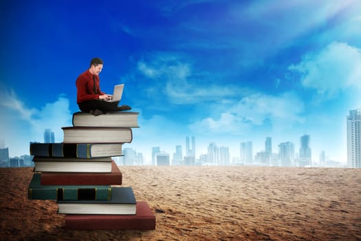 Business person working with laptop on the top of books. Career and education concept
