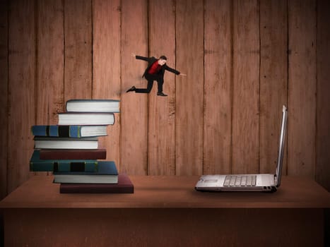Concept of technology migration with business person jumping from book to laptop