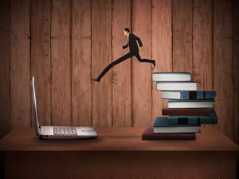 Concept of technology migration with business person jumping from book to laptop