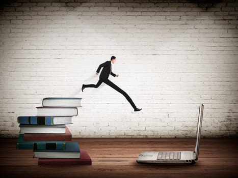 Concept of technology migration with business person jumping from book to laptop