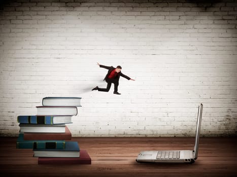 Concept of technology migration with business person jumping from book to laptop