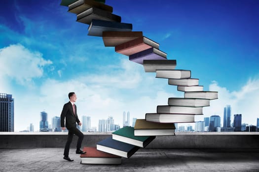 Business person step up flying book that look like stair. Career and education concept