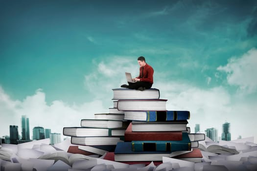 Asian business person working with laptop sit on top of book. Idea and knowledge concept