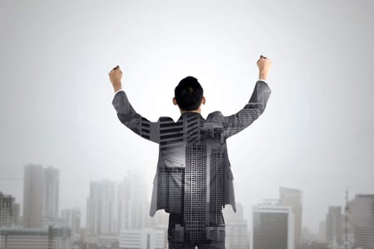 Double exposure of business man raise his hands. Business success conceptual.