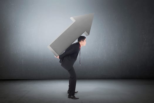 Asian young business man carry big arrow on grunge background