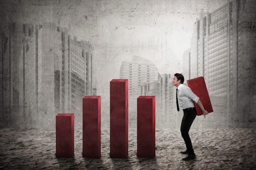 Asian business man carry heavy chart bar. Business development concept