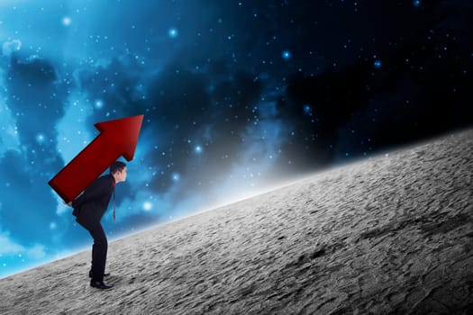 Asian business man carry big red arrow on his back. Business difficulty concept