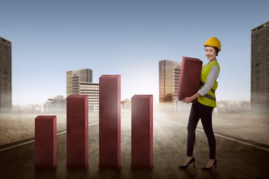 Asian business woman lifting block of chart. Business challenge concept