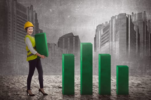 Asian business woman lifting block of chart. Business challenge concept