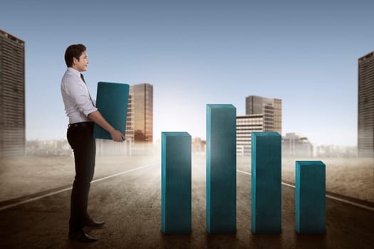 Asian business man carry heavy chart bar. Business development concept