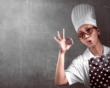 Portrait of young woman chef over abstract background