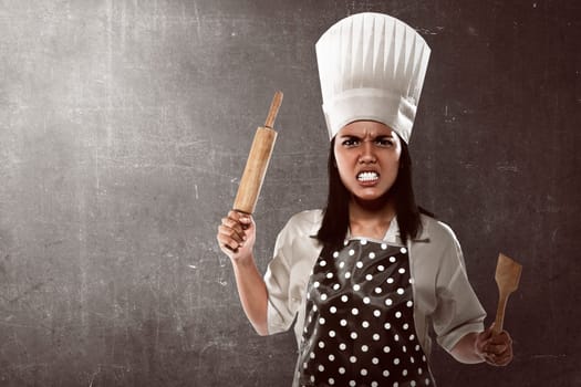 Angry asian woman chef over over abstract background