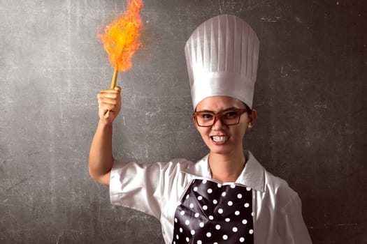 Portrait of angry young woman chef over abstract background