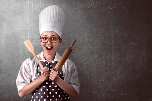 Portrait of young woman chef over abstract background
