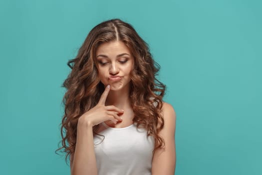 The young woman's portrait with sad emotions at studio