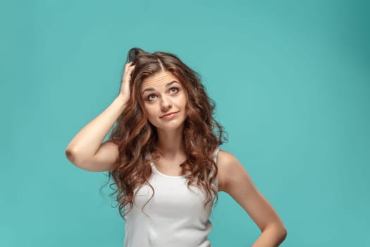 The portrait of alarmed young woman with shocked facial expression