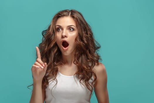 The portrait of alarmed young woman with shocked facial expression
