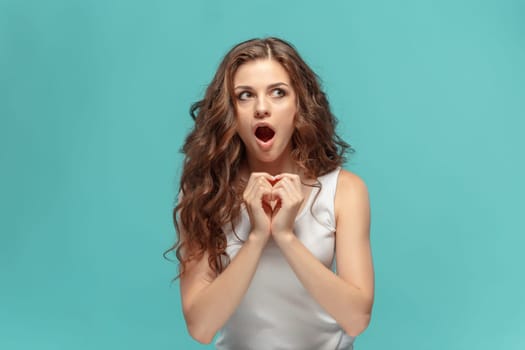 The portrait of alarmed young woman with shocked facial expression