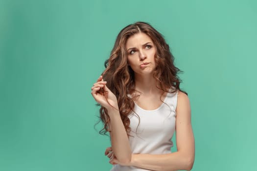 The young woman's portrait with sad emotions at studio